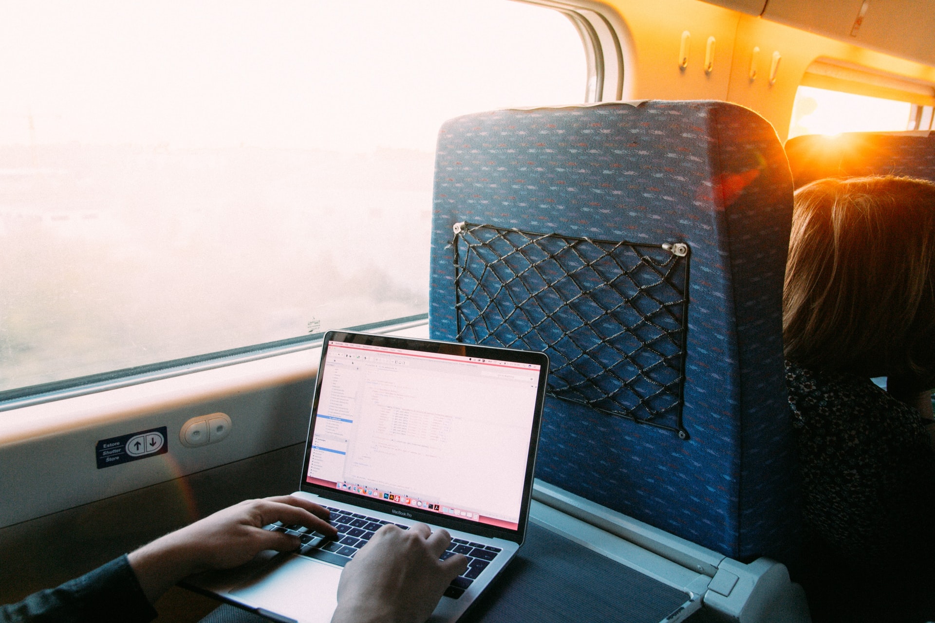 working on a laptop on the train